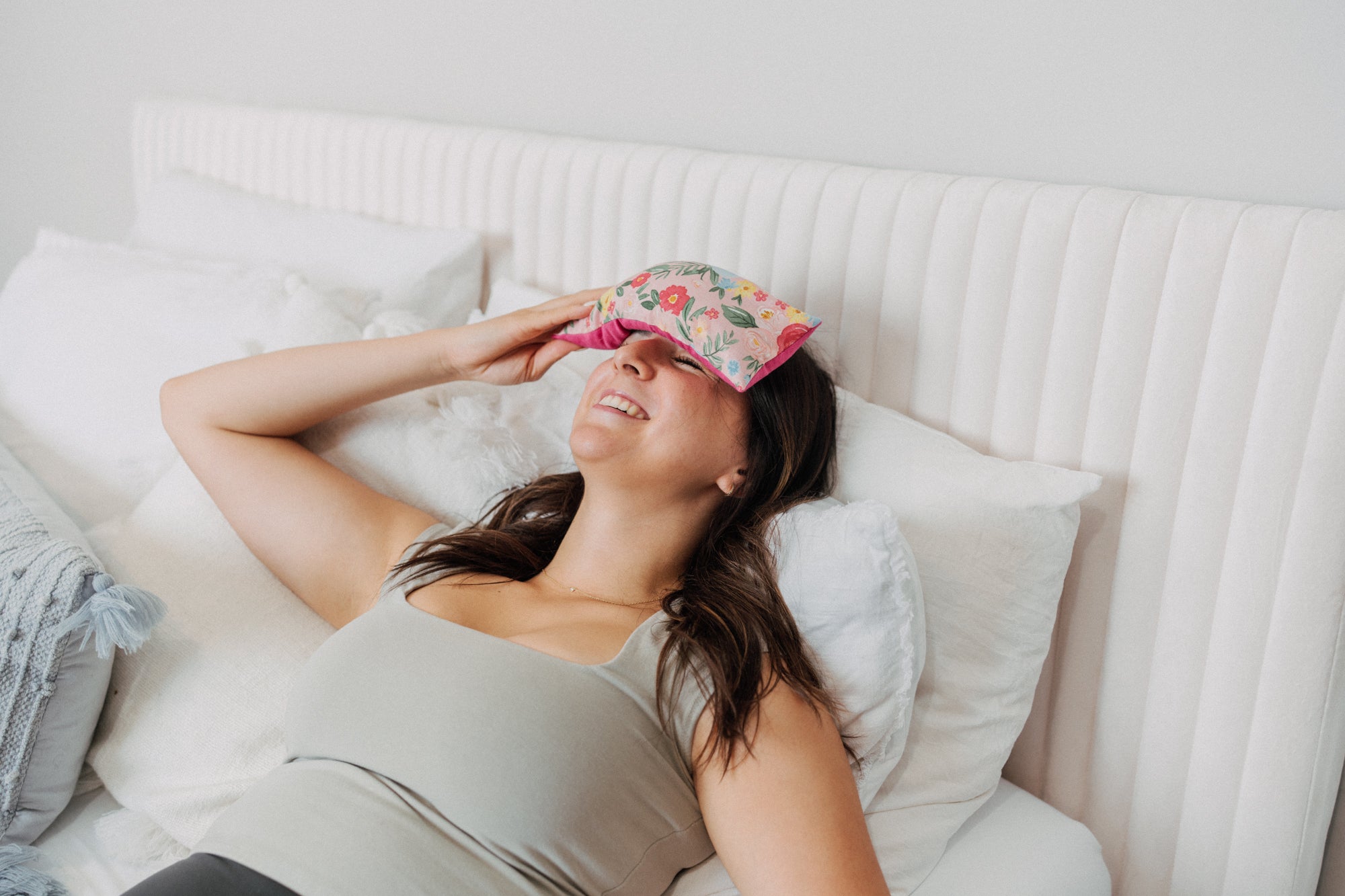 lady with a pink floral eye pillow over her dry eyes