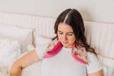 lady with pink floral microwavable neck wrap on neck and shoulders
