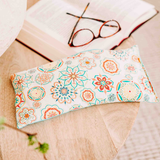 6' x 12" microwavable heating pad hot and cold pack in a pretty bright blue and white fabric, bowl of flax seed and herbs showing what is inside