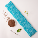 5" x 23" microwavable neck wrap hot and cold pack in pretty blue and green foliage print on white, bowl of flax seed and herbs showing what is inside